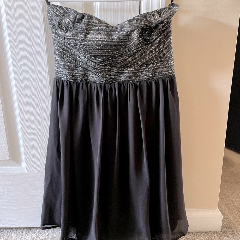 Boutique cocktail dress. Strapless. Black with silver/black design at the top.